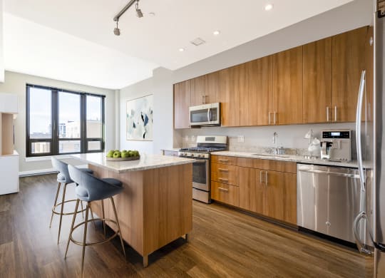 a kitchen with wooden cabinets and stainless steel appliances  at The Bartlett, Arlington, 22202