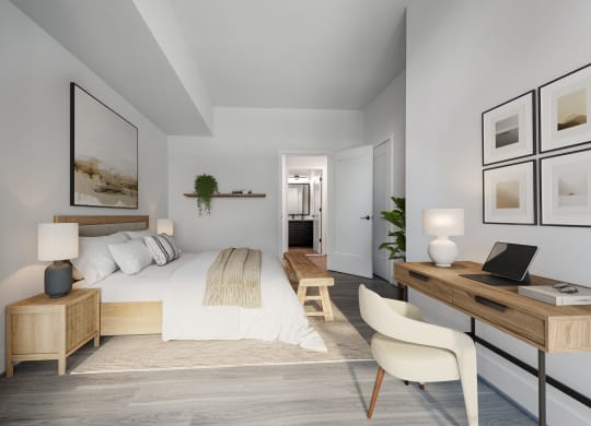 a bedroom with a large bed and a desk with a laptop at The Grace and Reva, Virginia
