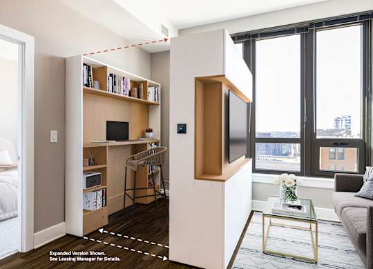 A modern living room with a TV, a couch, and a desk.