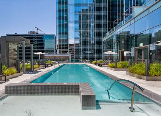 A swimming pool with a metal diving board in the middle of it.