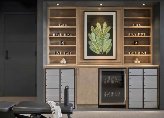 a room filled with furniture and a large painting of a plant