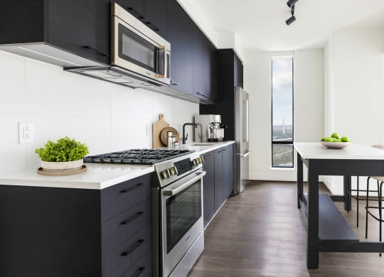 a kitchen with a table and a stove and a microwave at The Grace and Reva, Arlington, Virginia