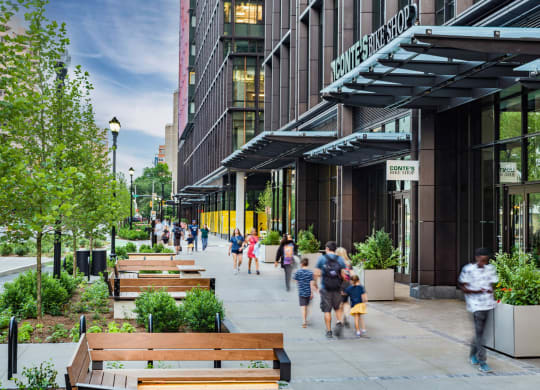 people walking on a sidewalk outside of a building at The Grace and Reva, Arlington, Virginia