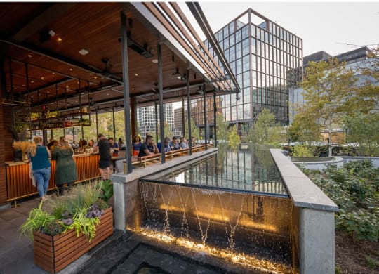 people sitting at a restaurant next to a water fountain at The Grace and Reva, Arlington, Virginia