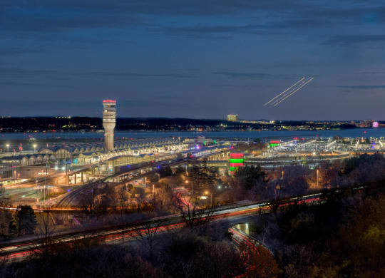a night view of the airport and the city at night at The Grace and Reva, Arlington, Virginia