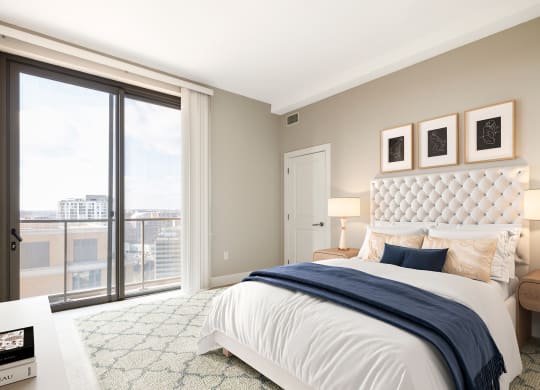 a bedroom with a large bed and a large window  at The Bartlett, Arlington, VA, 22202
