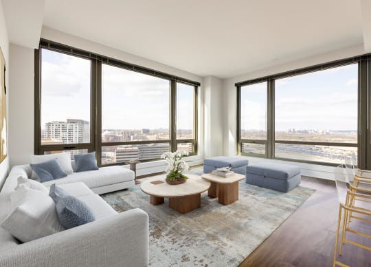 a living room with a large window and a view of the city  at The Bartlett, Arlington, Virginia