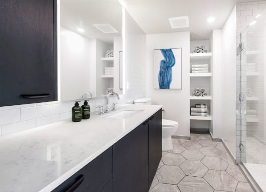 a bathroom with a sink toilet and shower