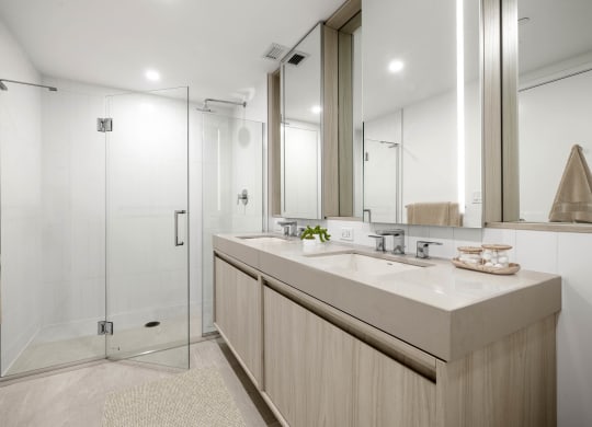 a bathroom with a large mirror and a glass shower