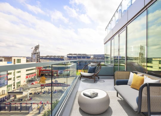 a balcony with a couch a chair and a table