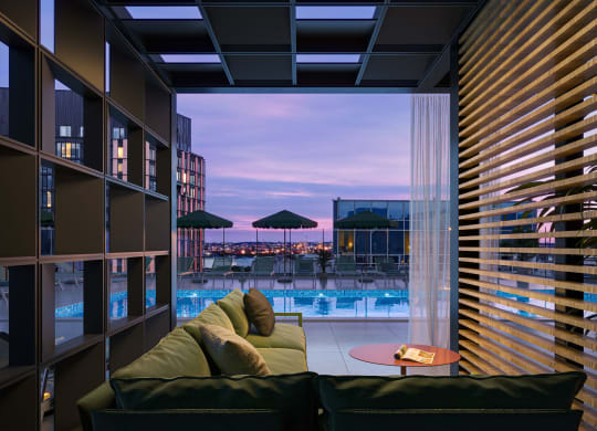 a living room with a couch and a view of a swimming pool