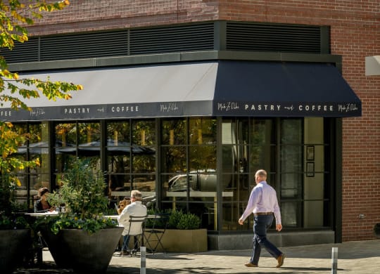 a man walking down the street in front of a building