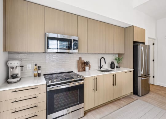 a kitchen with wooden cabinets and stainless steel appliances