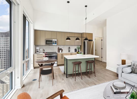 a living room with a kitchen and a table with chairs