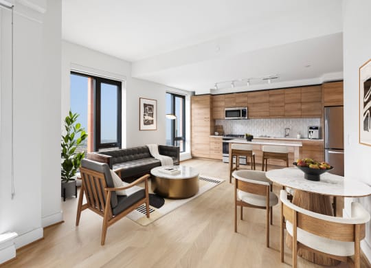 an open living room with a kitchen and a table at The Grace and Reva, Arlington, VA