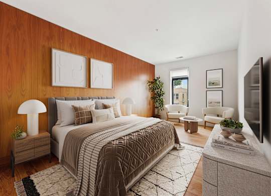 A bedroom with a large bed and a flat screen TV.