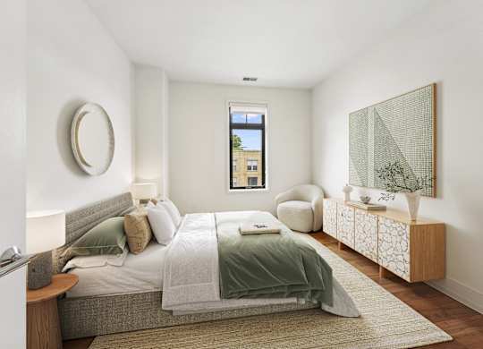 A bedroom with a bed, a chair, and a painting on the wall.