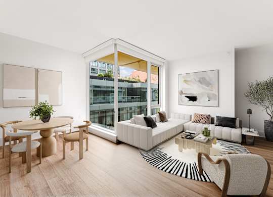 A living room with a white sofa, a wooden table and a zebra print rug.