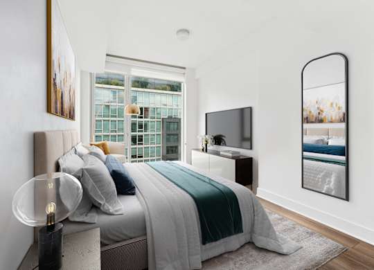 A modern bedroom with a large bed and a flat screen TV.
