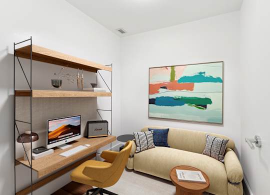 A room with a yellow chair and a couch with a painting on the wall.