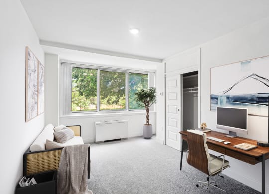 a home office with a desk and a window