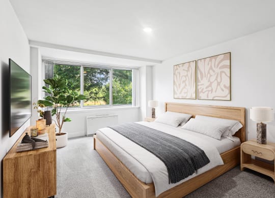 a bedroom with a bed and a large window