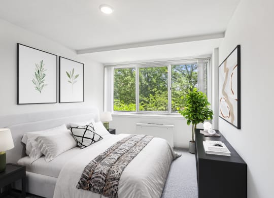 a bedroom with a bed and a large window
