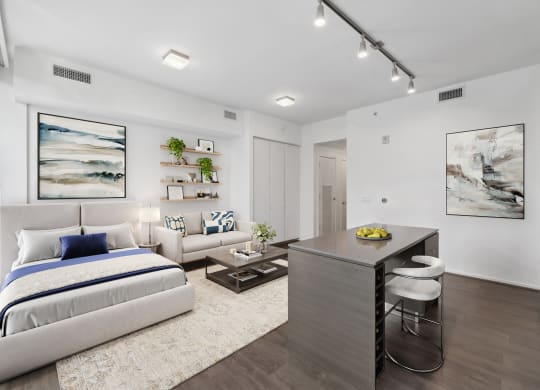 a bedroom with a bed and a desk and a living room