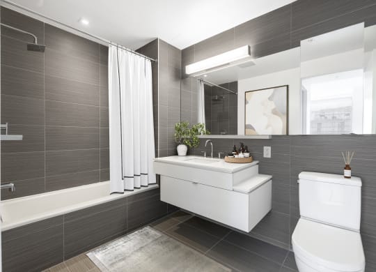 a bathroom with a toilet sink and a mirror