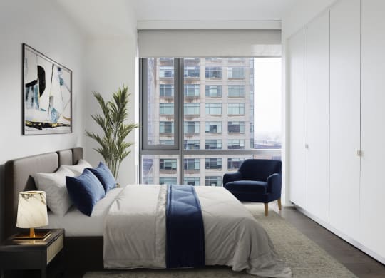 a bedroom with a bed and a large window