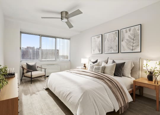 a bedroom with a large bed and a ceiling fan