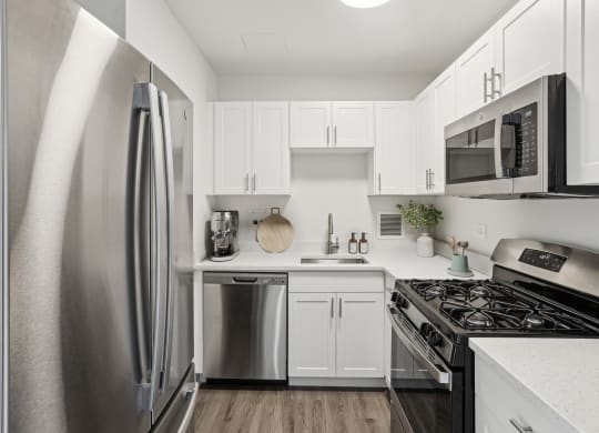 a kitchen with stainless steel appliances and white cabinets