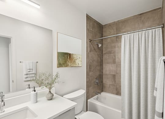 a bathroom with a shower and a toilet and a sink