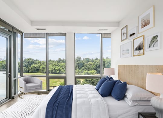a bedroom with a bed and a view of a large window