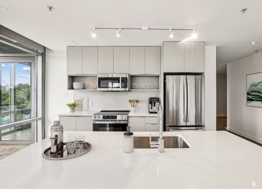 a kitchen with white counter tops and a sink