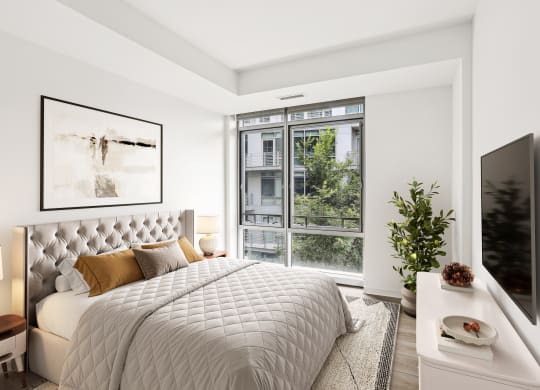a bedroom with a bed and a large window