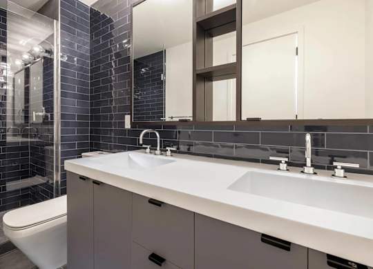 A bathroom with a white sink and a white toilet.