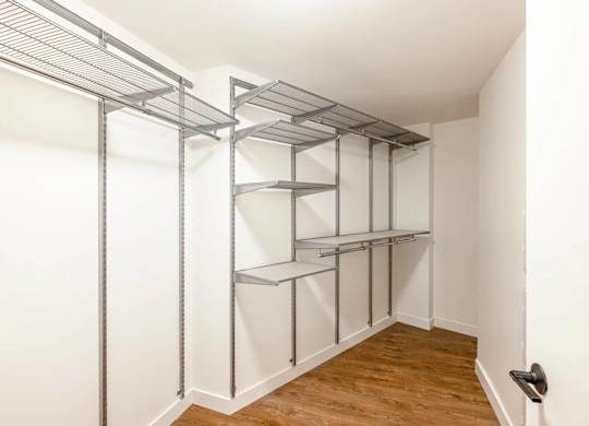 A white wall with a shelving unit on it.