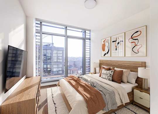 A bedroom with a large bed and a flat screen TV.