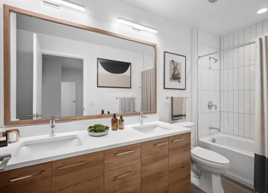 a bathroom with two sinks and a large mirror at The Grace and Reva, Virginia, 22202