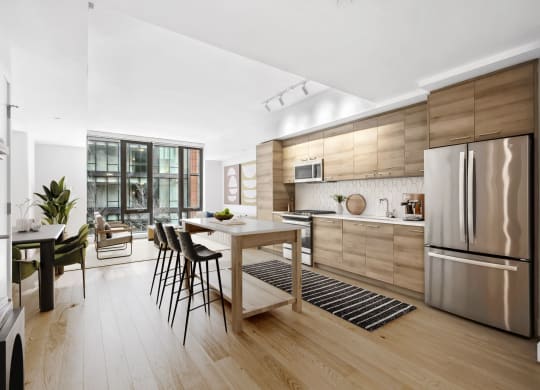 a kitchen with wooden cabinetry and stainless steel appliances at The Grace and Reva, Arlington, VA