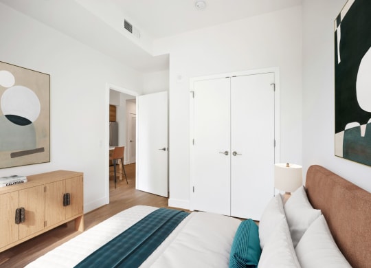 a bedroom with a bed and a closet at The Grace and Reva, Arlington, 22202