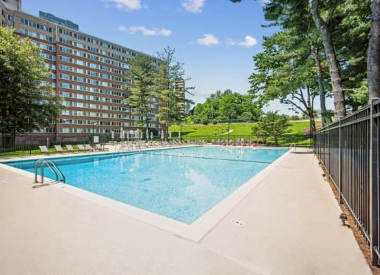 a large swimming pool in front of a building