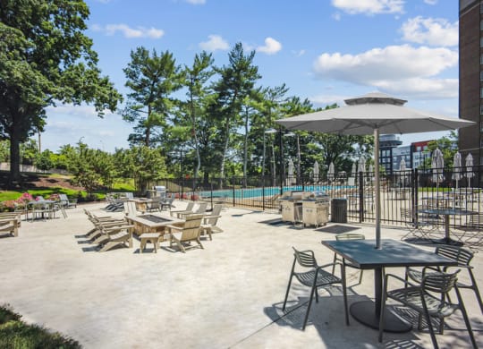 a patio with tables and chairs and a swimming pool