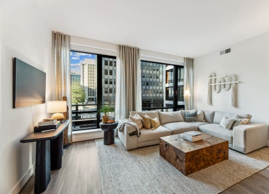 a living room with a couch and a coffee table and large windows at The Grace and Reva, Virginia