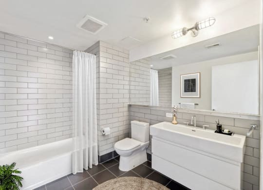 a white bathroom with a toilet and a sink