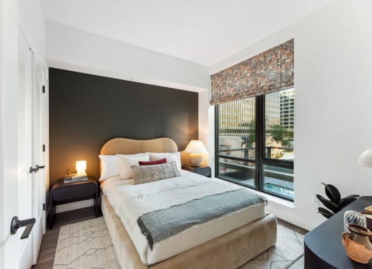 a bedroom with a bed and a large window at The Grace and Reva, Arlington, Virginia