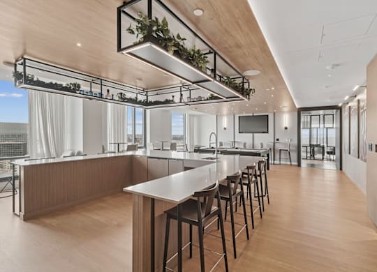 A modern kitchen with wooden floors and a long island.