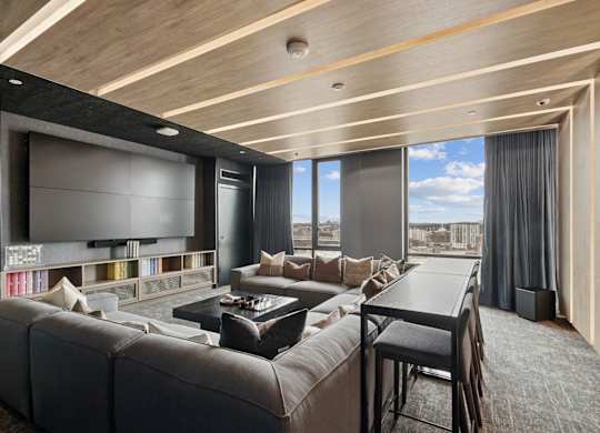 A modern living room with a large couch and a television.