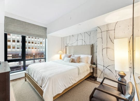 a bedroom with a large bed and a large window at The Grace and Reva, Arlington